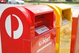 Australia post boxes, red in foreground, yellow alongside