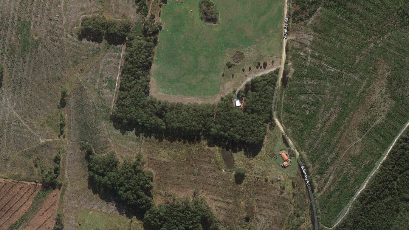 A satellite map view of a road and rural properties.