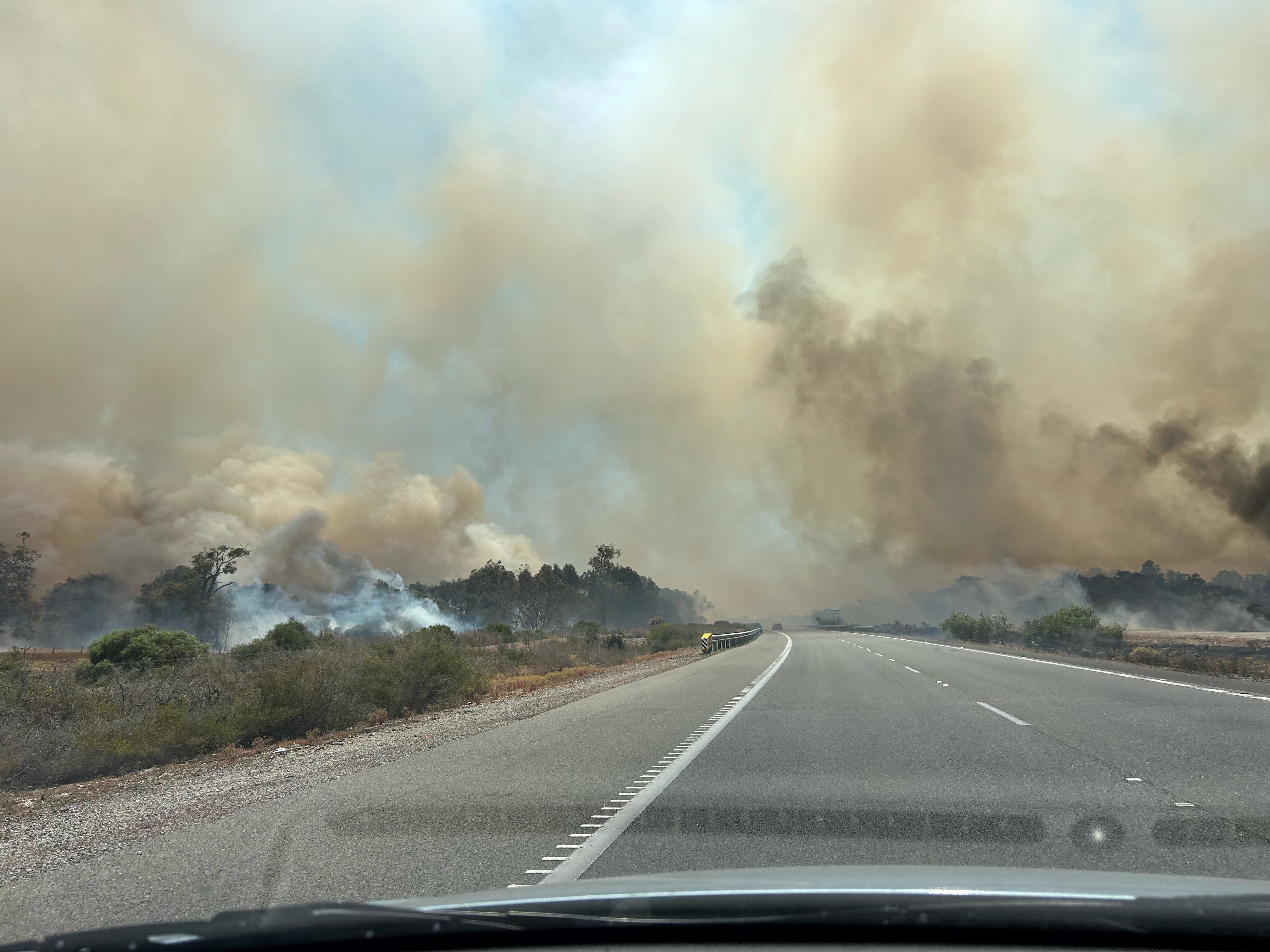 A plume of smoke over a freeway