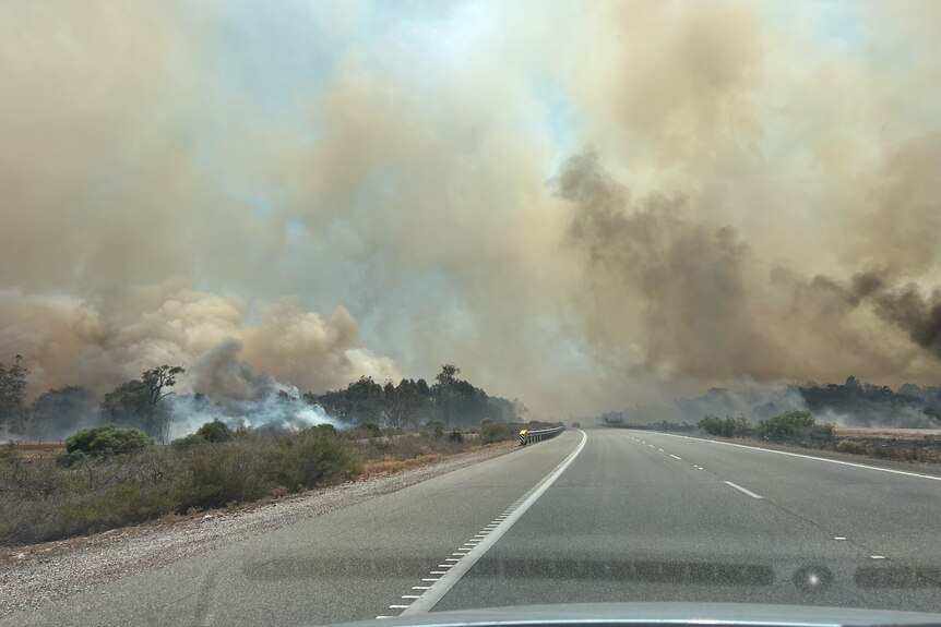 A plume of smoke over a freeway
