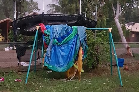 Lawn furniture strewn around by a storm in katherine.