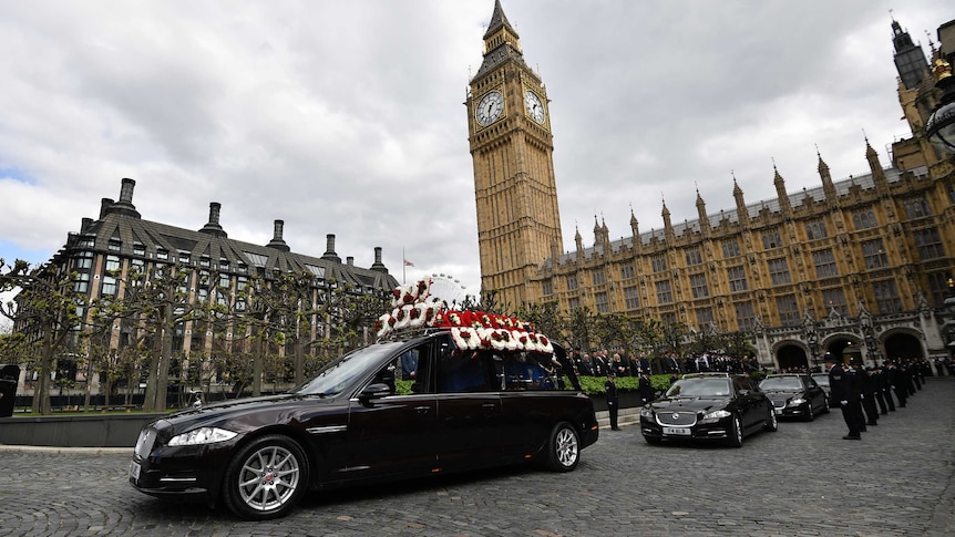 A  black hearse bears Keith Palmer's body under the spire of Big Ben.
