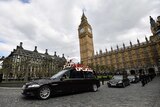 A  black hearse bears Keith Palmer's body under the spire of Big Ben.