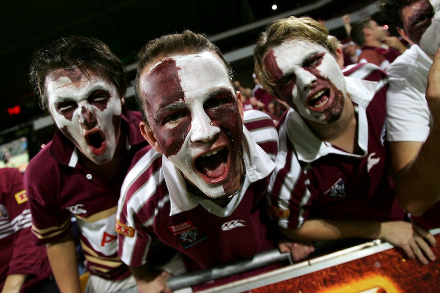 A group of Queensland fans celebrate a win