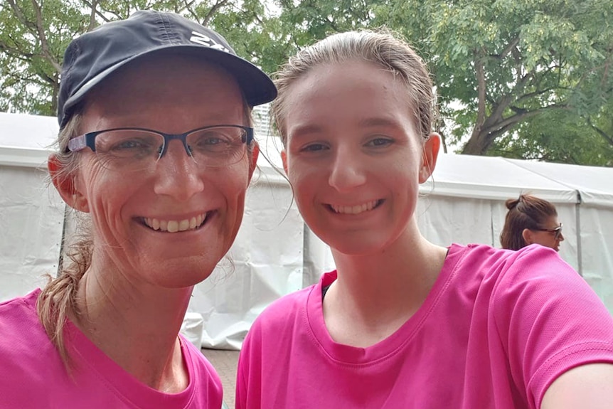 Julie Richards and her daughter Jessica Richards wearing pink fun run t-shirts smile in a selfie.