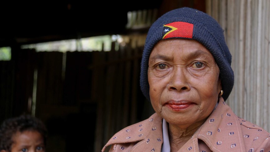 Timorese woman with the Timor-Leste flag beanie on.