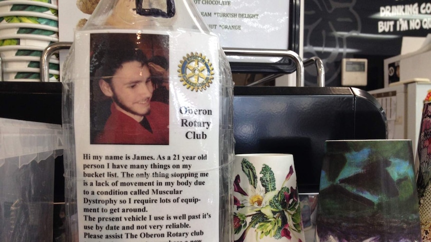 A bottle with a note taped to the front with details about fundraising for a vehicle for James Baxter