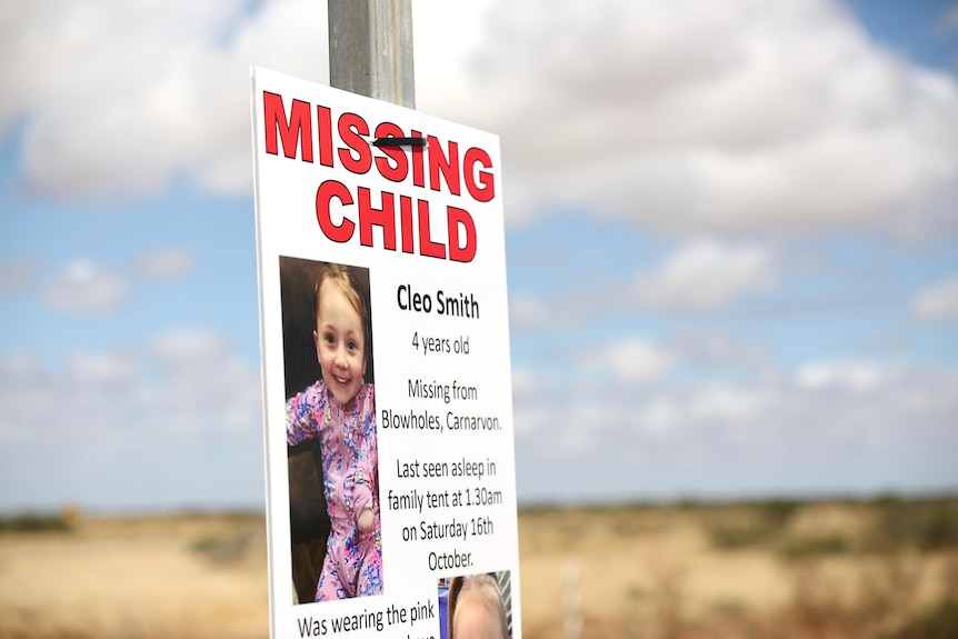 A poster on a sign in a rural area reading missing child