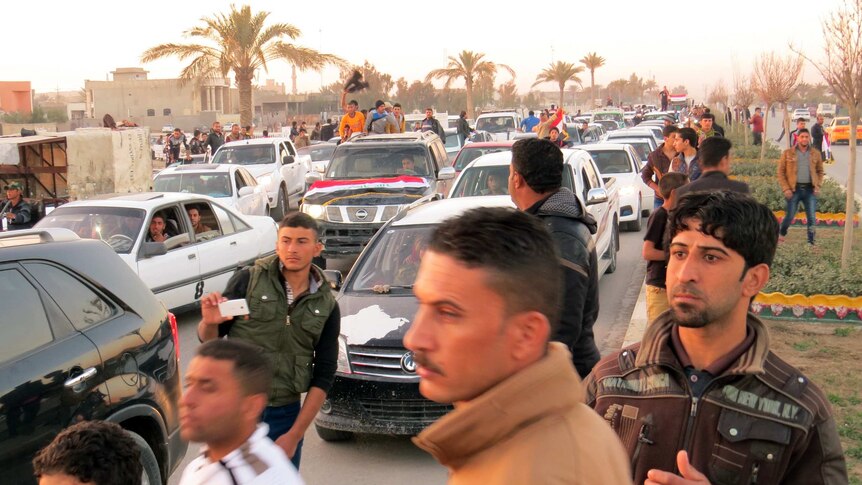 Iraqi civilians watch as Ramadi is recaptured.