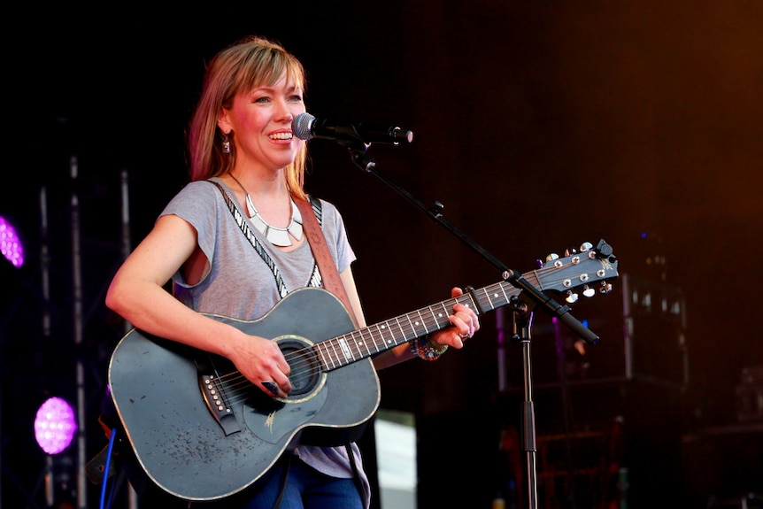 Felicity Urquhart holds a black guitar on stage at the Gympie Muster in 2015.