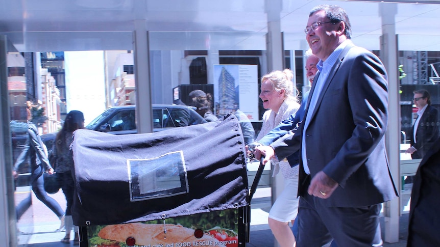 Alannah McTiernan, Terry Condipodero and Eddie Rigg with the food cart on the streets of Perth