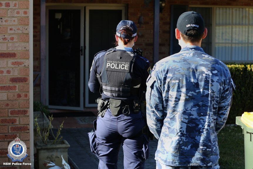 Police and Air Force officer conduct COVID compliance check