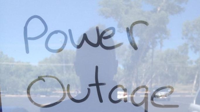 A sign saying closure due to power outage