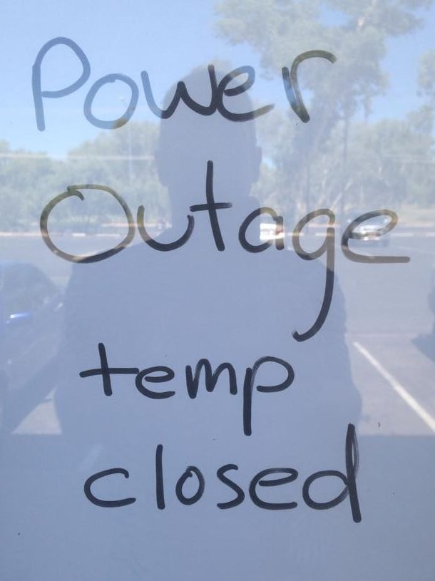 A sign saying closure due to power outage