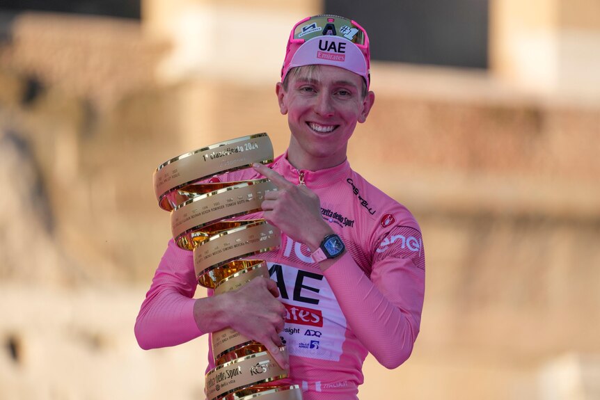 Tadej Pogacar holds the Giro trophy