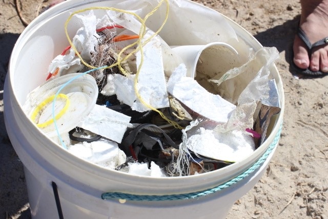 A bucket filled with plastic rubbish