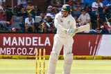 Usman Khawaja watches the ball.