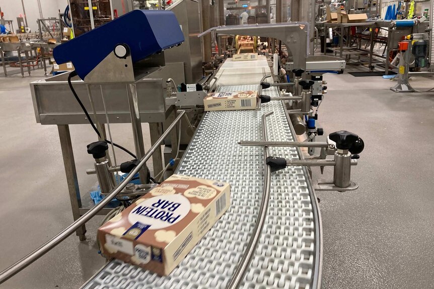 The inside of the ice-cream factory with a box of iceblocks on a conveyer belt