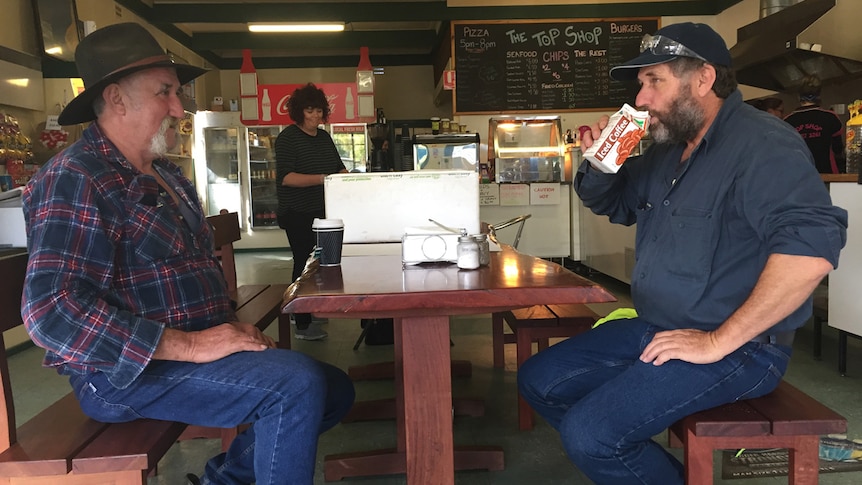 Jack Britton watches Mark Britton take a sip of Kiewa milk.