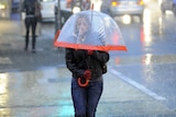 A pedestrian tackles the wild weather