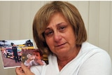Adriana Buccianti holds photos of her son, Daniel, who died in 2012 of a drug overdose.