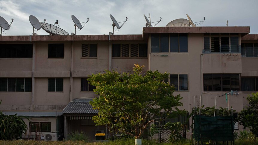 Satellites lining the rooftop of a block of units on Christmas Island.