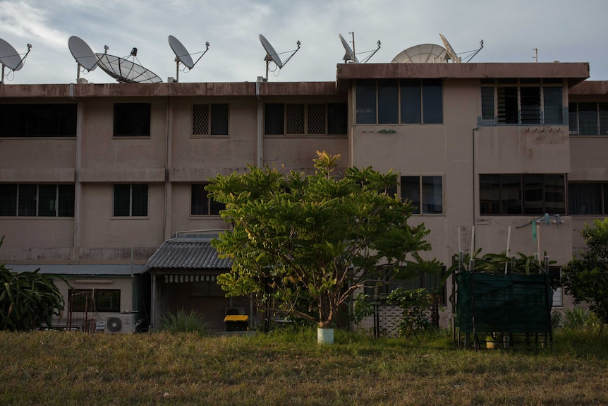 Satellites lining the rooftop of a block of units on Christmas Island.