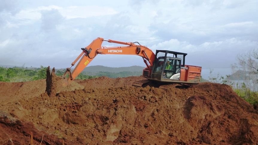 An excavator digs dirt at Axiom Mining's nickel operation in Isabel province, Solomon Islands.