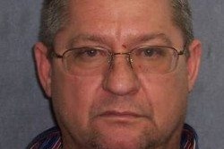 A police mugshot of alleged drug dearler Robert Gee — a middle-aged man wearing glasses.