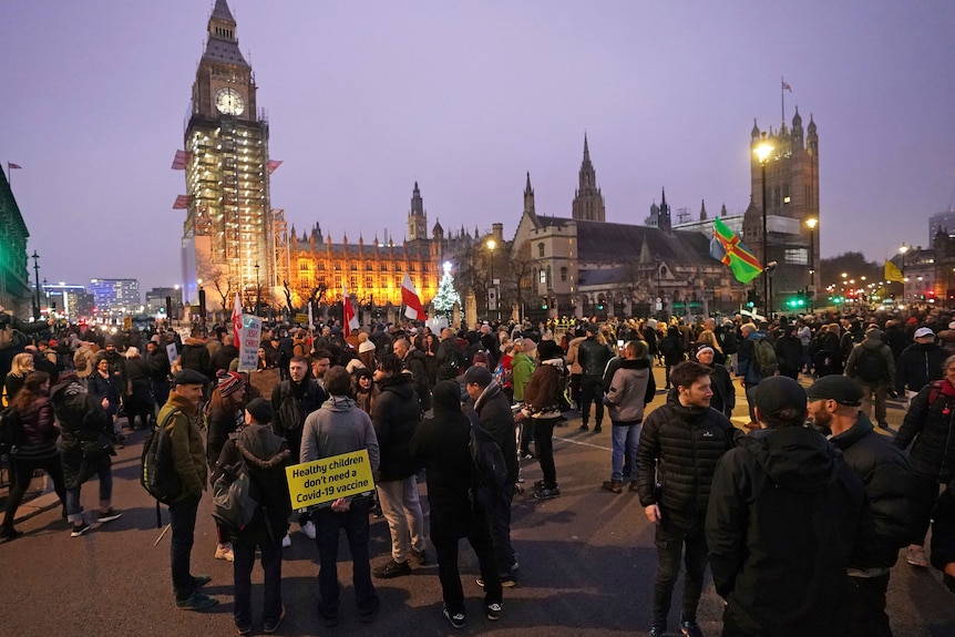 Hundreds of people outside Parliament Square in London not wearing masks and holding anti vaccination signs 