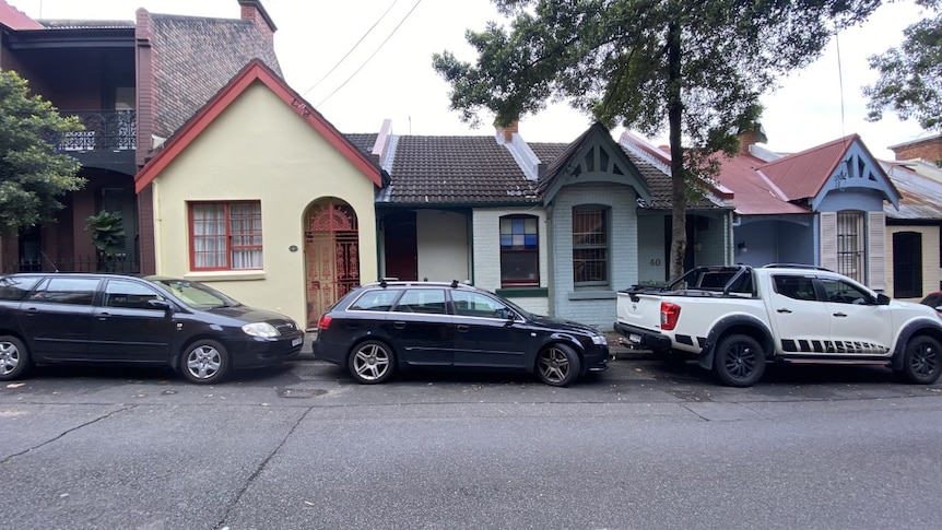 Three cars parked along a residential street in Sydney.