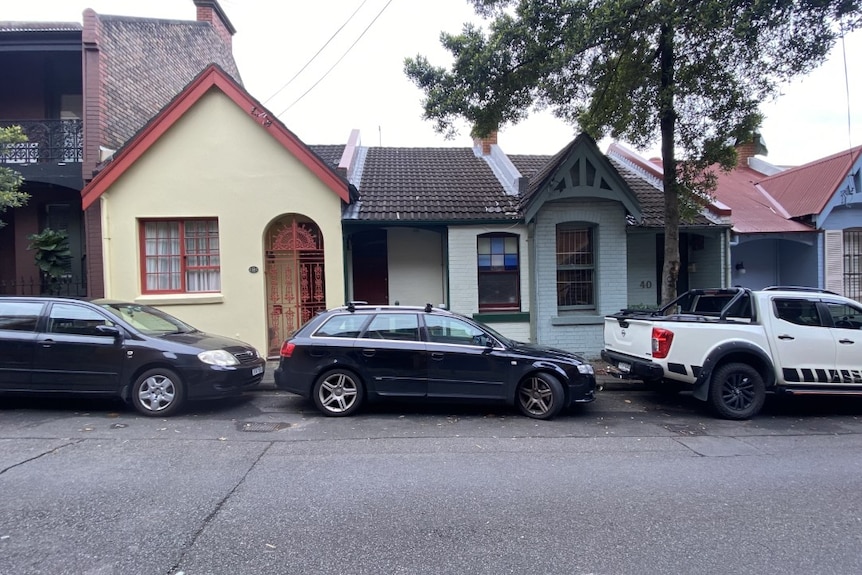 Three cars parked along a residential street in Sydney.