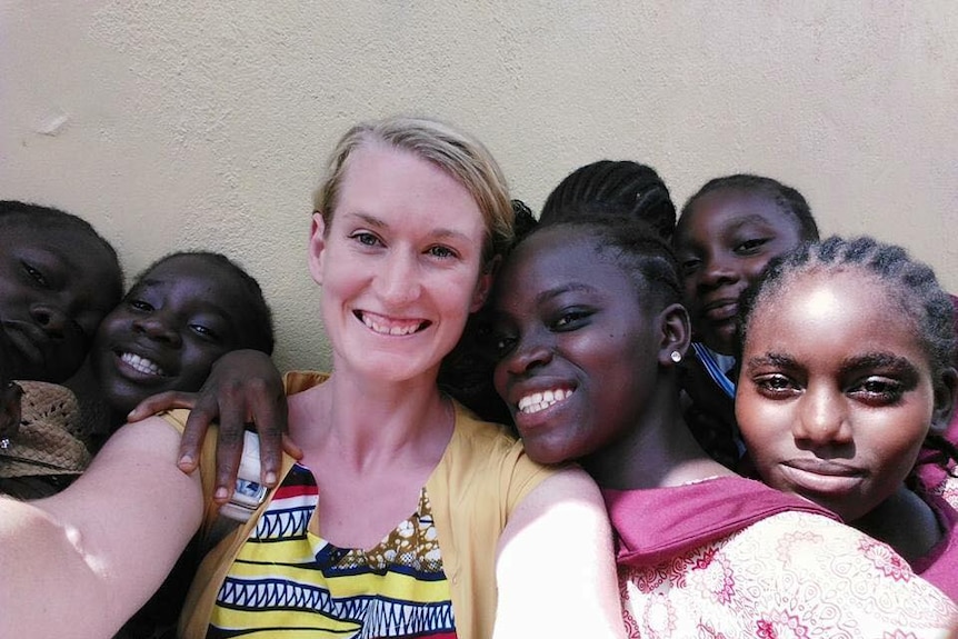 Monique Bolus takes a selfie with a group of Liberian school students.