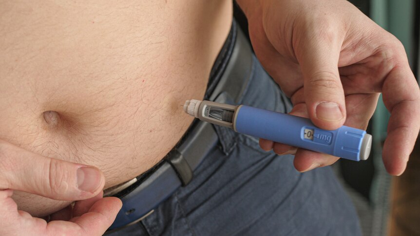 A close-up of a man's stomach being injected with semaglutide