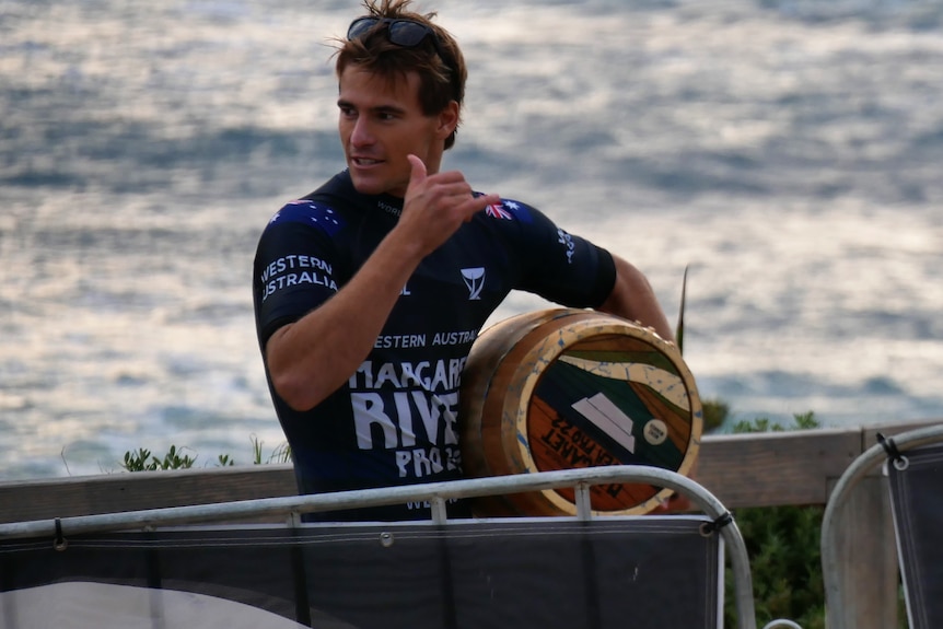 A man holding a wine barrel