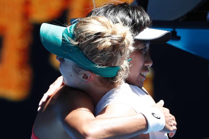 Elina Svitolina and Zhang Shuai hug at the net at the Australian Open.
