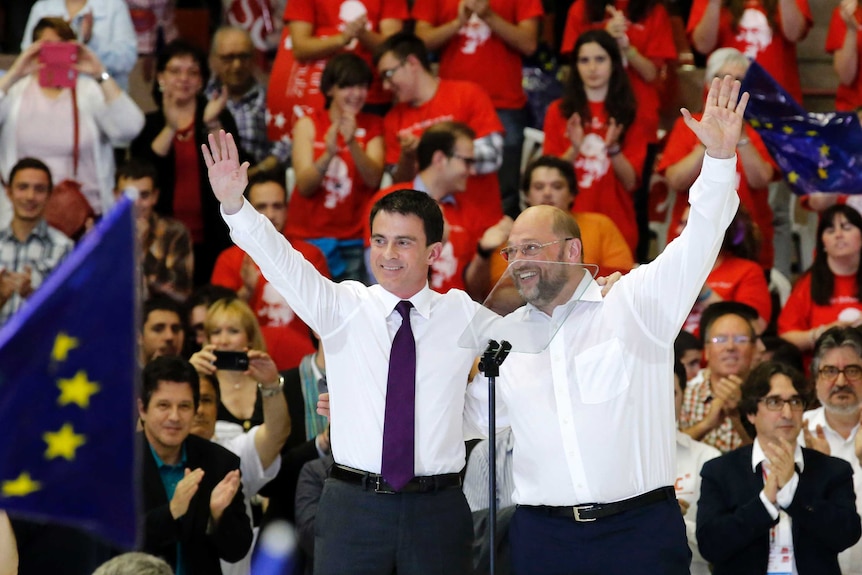 LtoR Manuel Valls and  Martin Schulz wave to the crowd at a campaign rally in Barcelona, Spain.