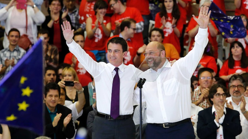 LtoR Manuel Valls and  Martin Schulz wave to the crowd at a campaign rally in Barcelona, Spain.