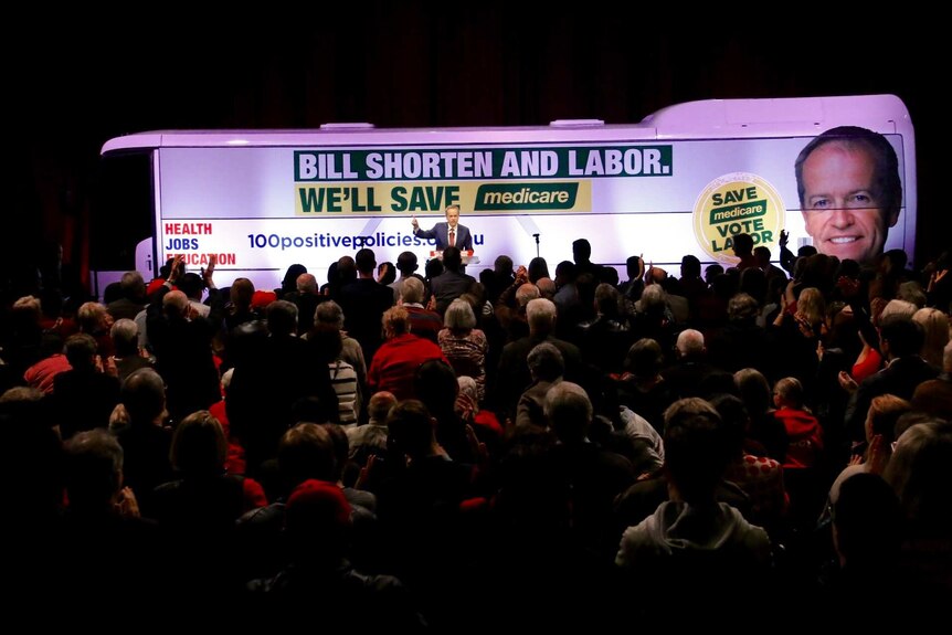 Bill Shorten, standing on a stage in front of a bus with Labor advertising, speaks to a crowd on Sunday June 26, 2016.