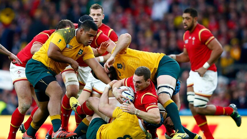 Stunning defence ... Wales centre George North is tackled by Wallabies back rower David Pocock