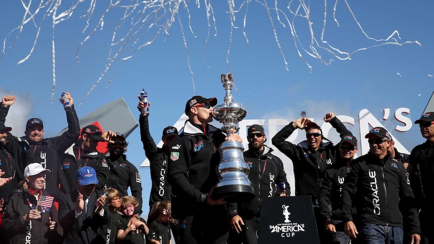 Jimmy Spithill kisses the America's Cup.
