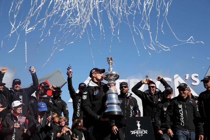 Jimmy Spithill kisses the America's Cup.