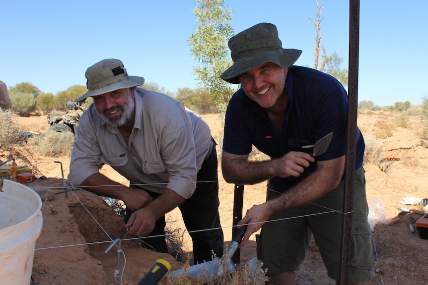 Archaeologists Doug Williams and Dr Michael Westaway stand above the skeletal excavation.