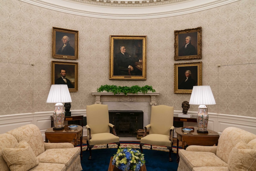 Portraits of former presidents and US political leaders inside Oval Office.