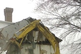 An excavation digger demolishes the Lands End mansion in Sands Point, New York