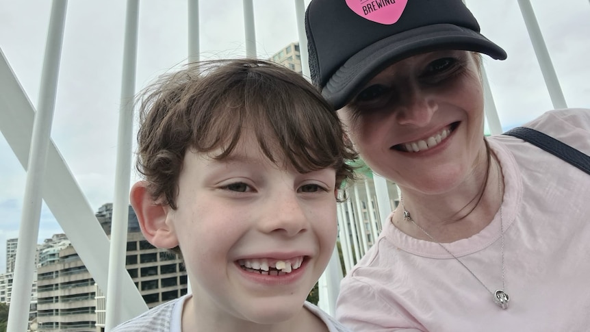 a young boy smiling with a woman smiling