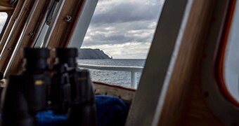 The RV Investigator rounds Cape Pillar in Tasmania's South East.