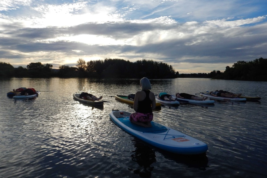 SUP yoga meditation on Lake Burley Griffin.