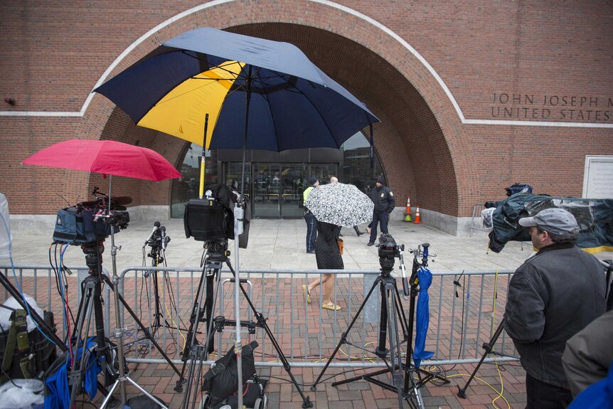Television crews wait outside a courthouse in the trial of Boston bombing suspect Dzhokhar Tsarnaev