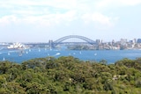 Sydney harbour with full view of the bridge and opera house.